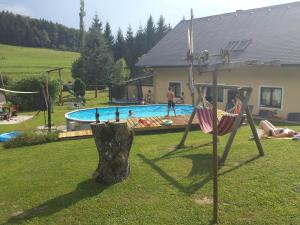 a group of people in a yard with a pool at Weingut Lieschnegg in Leutschach