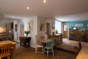 a restaurant with a table and chairs and a counter at Bertram's in Warkworth