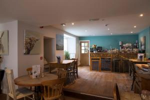 a restaurant with tables and chairs and a bar at Bertram's in Warkworth