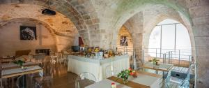 a restaurant with arched ceilings and tables and chairs at Corte Dei Francesi in Maglie