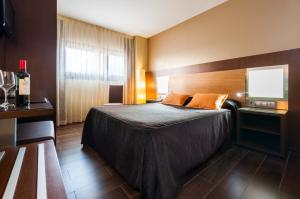 Postel nebo postele na pokoji v ubytování Hotel Ciudad de Alcañiz