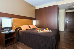 Postel nebo postele na pokoji v ubytování Hotel Ciudad de Alcañiz