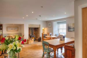 a dining room and living room with a table and chairs at Bertram's in Warkworth