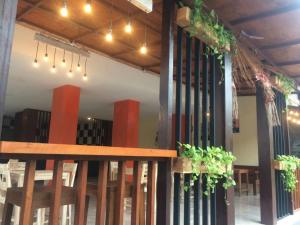 a restaurant with a table and some plants on the wall at Sari Room Bed & Breakfast in Nusa Dua