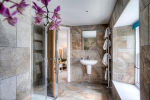 a bathroom with a shower and a sink at Bertram's in Warkworth +23 photos
