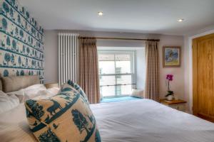a bedroom with a bed and a window at Bertram's in Warkworth