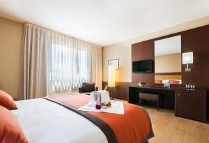 Postel nebo postele na pokoji v ubytování Hotel Ciudad de Alcañiz