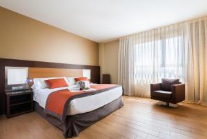 Postel nebo postele na pokoji v ubytování Hotel Ciudad de Alcañiz