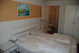 a bedroom with a bed with two pillows on it at Apartment - Lille Galleri - Fyresdal in Fyresdal