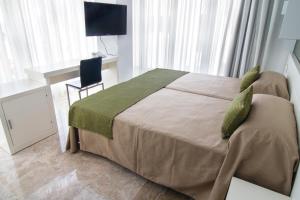 מיטה או מיטות בחדר ב-Hotel Senderos