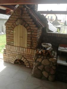 a brick oven with a door on top of it at U Agi in Nowogród