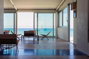 a living room with a view of the ocean at Hotel Amyclae in Sperlonga