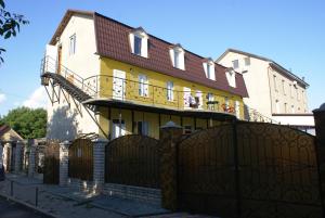 a house with a gate and a fence at Marinus in Gribovka