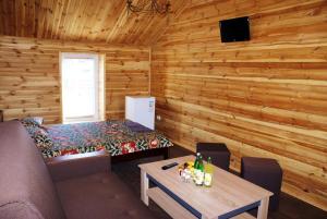 a room with a bed and a table in a cabin at Marinus in Gribovka