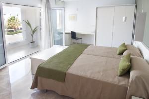 מיטה או מיטות בחדר ב-Hotel Senderos