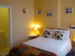 A bed or beds in a room at The North Euston Hotel 