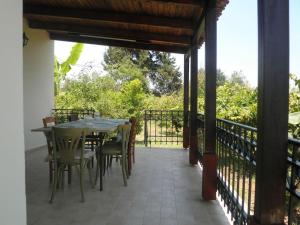 a patio with a table and chairs on a balcony at Dimis Country House in Arménoi