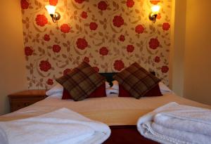 a bedroom with a bed with two towels on it at Swinside Inn in Keswick