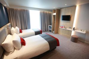 a hotel room with two beds and a television at Holiday Inn Express - Manchester - TRAFFORDCITY, an IHG Hotel in Manchester