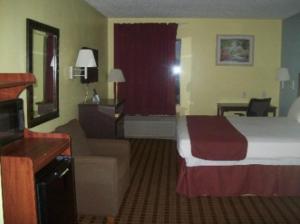 a hotel room with a bed and a desk at Fairway Inn La Porte in La Porte