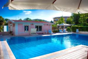 a swimming pool in front of a house at Hotel Gioia Garden in Fiuggi