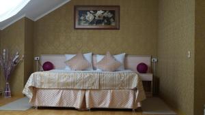 a bedroom with a bed and a painting on the wall at Мини-отель Iris Inn in Krasnodar