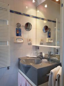 a bathroom with a sink and a mirror at Garni Rubens B&B in Selva di Val Gardena