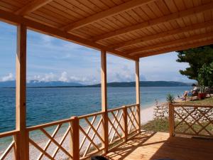 a view of the beach from the porch of a house at Victoria Mobilhome Camping Dole-Živogo&scaron;če in Blato