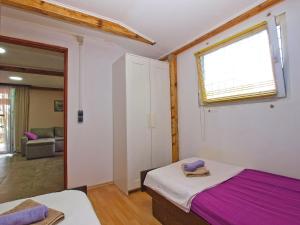 a bedroom with a bed and a window at House Nikola 1422 in Peroj