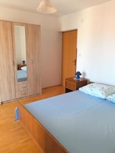 sypialnia z dużym łóżkiem i lustrem w obiekcie Lavanda w miejscowości Mali Lošinj