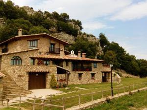 una casa de piedra frente a una montaña en Font D'en Torres Solo Adultos, en Morella