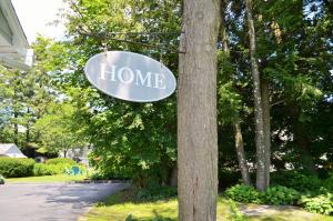 a home sign on a telephone pole next to a tree at Maple Terrace Motel in Williamstown