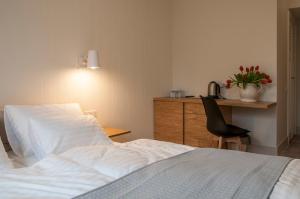 a bedroom with a bed and a desk and a chair at Baltica Residence in Sopot