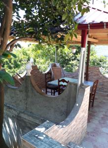 eine Terrasse mit einem Tisch und Stühlen unter einem Pavillon in der Unterkunft Konstantin House in Sarpi