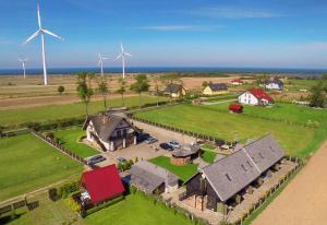 an aerial view of a farm with wind turbines at Pod Strzechą in Darłowo