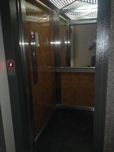 an elevator door with a mirror in a room at Marica Apartment in Plovdiv
