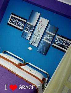 a wall with pictures of a bed in a room at Albergo B&B Ristorante Grace in Vibo Valentia