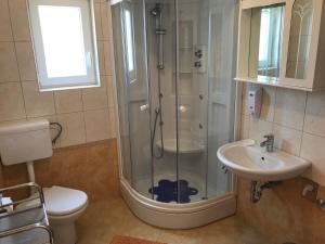 a bathroom with a shower and a toilet and a sink at Apartmani Marija Klimno B in Klimno +37 photos