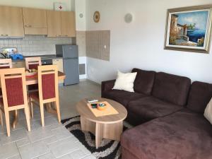 a living room with a couch and a table at Apartmani Marija Klimno B in Klimno