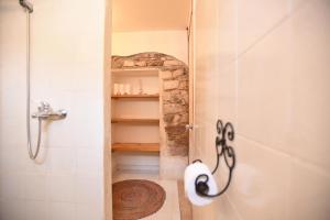 a bathroom with a shower with a glass door at Williams House in Eilat +37 photos