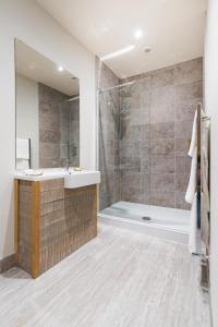 a bathroom with a sink and a shower at Forest in Burnley