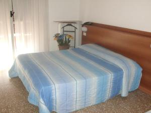 Postel nebo postele na pokoji v ubytování Hotel Lombardia