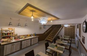 a restaurant with tables and a staircase in a room at Pensiunea Kant in Sibiu