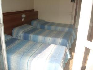 Postel nebo postele na pokoji v ubytování Hotel Lombardia