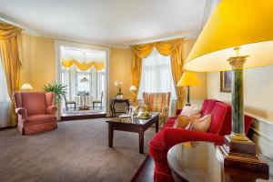 a living room with a couch and chairs and a table at Le Palais Art Hotel Prague in Prague