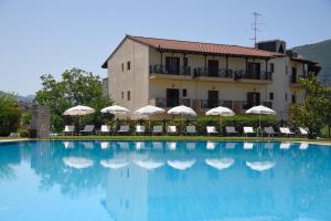 a large swimming pool in front of a building at Mont Helmos Hotel in Klitoria