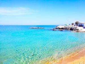 a view of a beach with blue water at Dimora Arco Antico in Monopoli