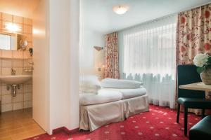 Postel nebo postele na pokoji v ubytování Alpenhotel Regina