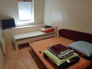 a room with a bed and a table and a window at Riverside Apartments with Sauna in Palanga