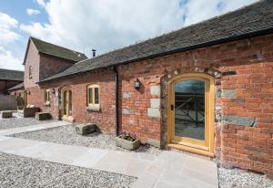 an external view of a brick building with a door at The Shippen in Great Chatwell